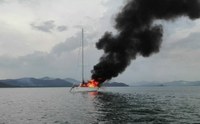 yacht at anchor in Phuket on fire