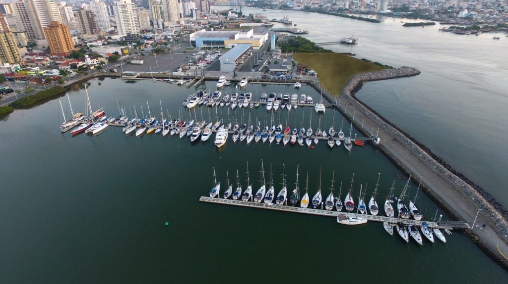 aerial view of a lagoon alongside a river with marina pontoons and boats moored