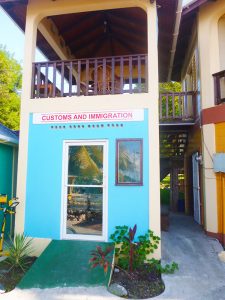 brightly coloured building housing the customs and immigration office