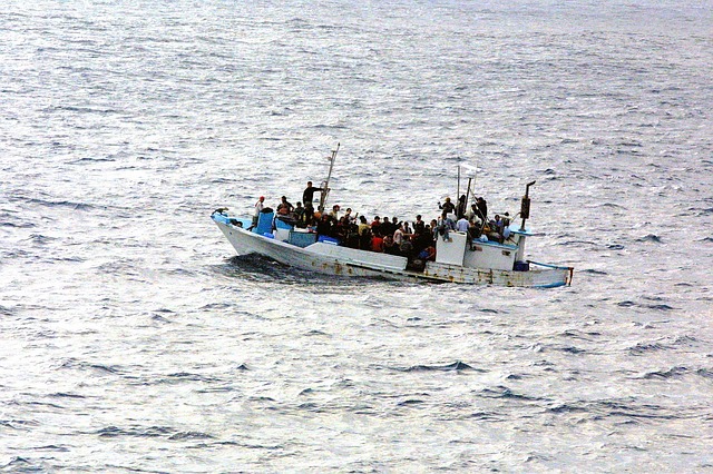a boat overloaded with people - refugees