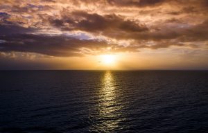 looking out to sea as the sun sets