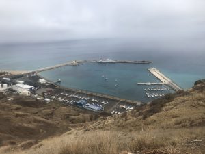 looking down on porto santo port surrounded by breakwaters with a small entrance and marina inside
