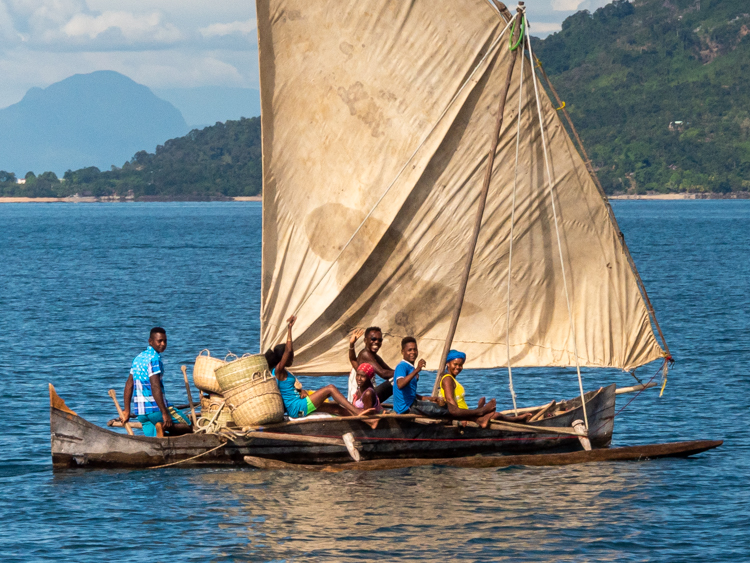 local sailing canoe with several local boys all loooking very happy on board