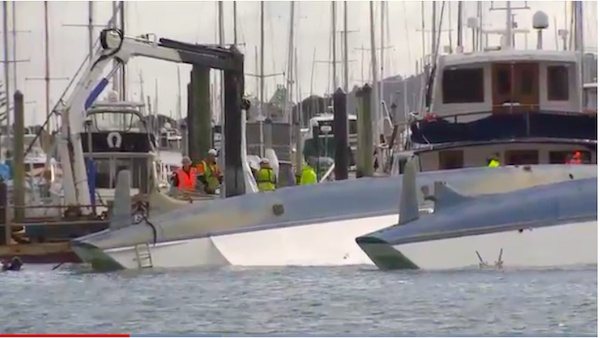 The catamaran Rosella upside down in the water 