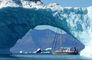 a yacht in the arctic surrounded by icebergs