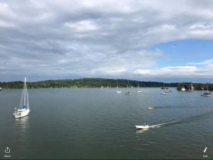 Calm bay with flat water and small speedboats and yachts at anchor