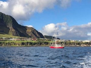 Red yacht at anchor in the harbour at Tristan Da Cunha