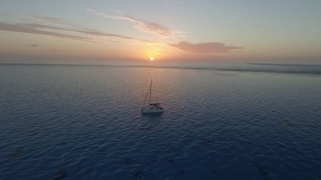 yacht at anchor at sunset