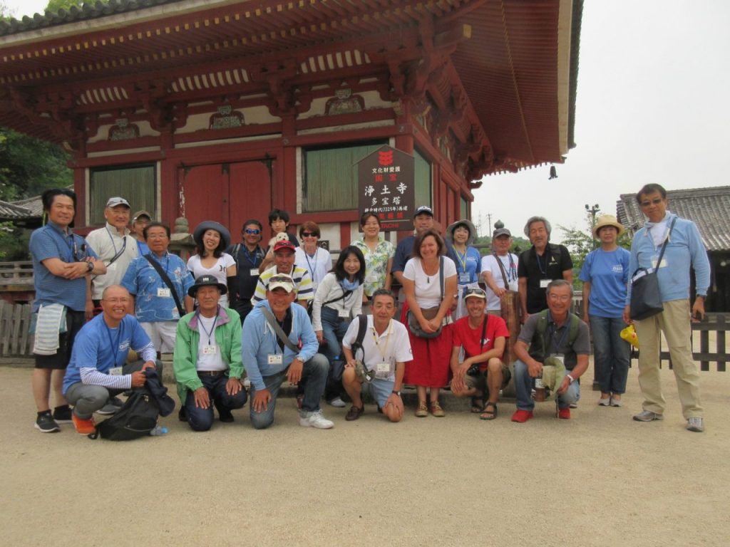 Group of people photographed in front of a Japanese temple