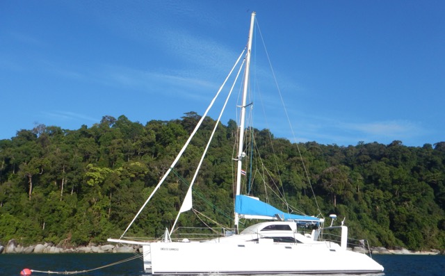 Catamaran moored off an island