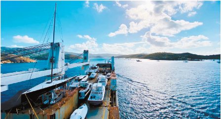 Boats on the deck of a yacht transport vessel.