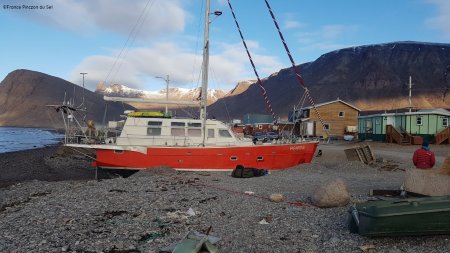 Yacht nestled in a pit on the beach.