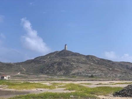 looking towards a hill with a lighthouse on top.